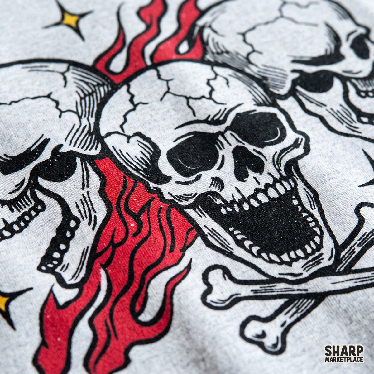 Three screaming skulls with burning red flames and crossbones edgy biker tattoo flash clipart for spooky Halloween t-shirts