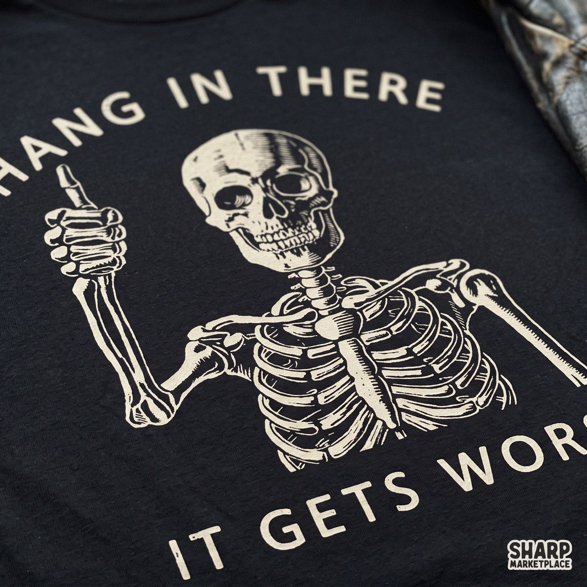 Sarcastic retro skull PNG graphic with thumbs up and Hang In There It Gets Worse text for dark humor apparel