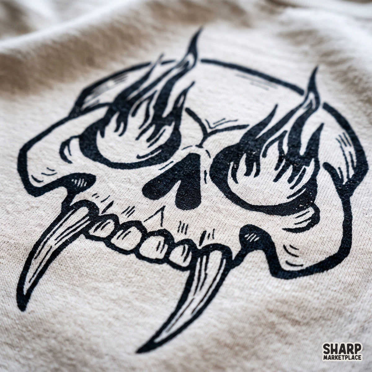 Woodcut fanged skull design with eye flames for Halloween t-shirts and gothic streetwear PNG clipart