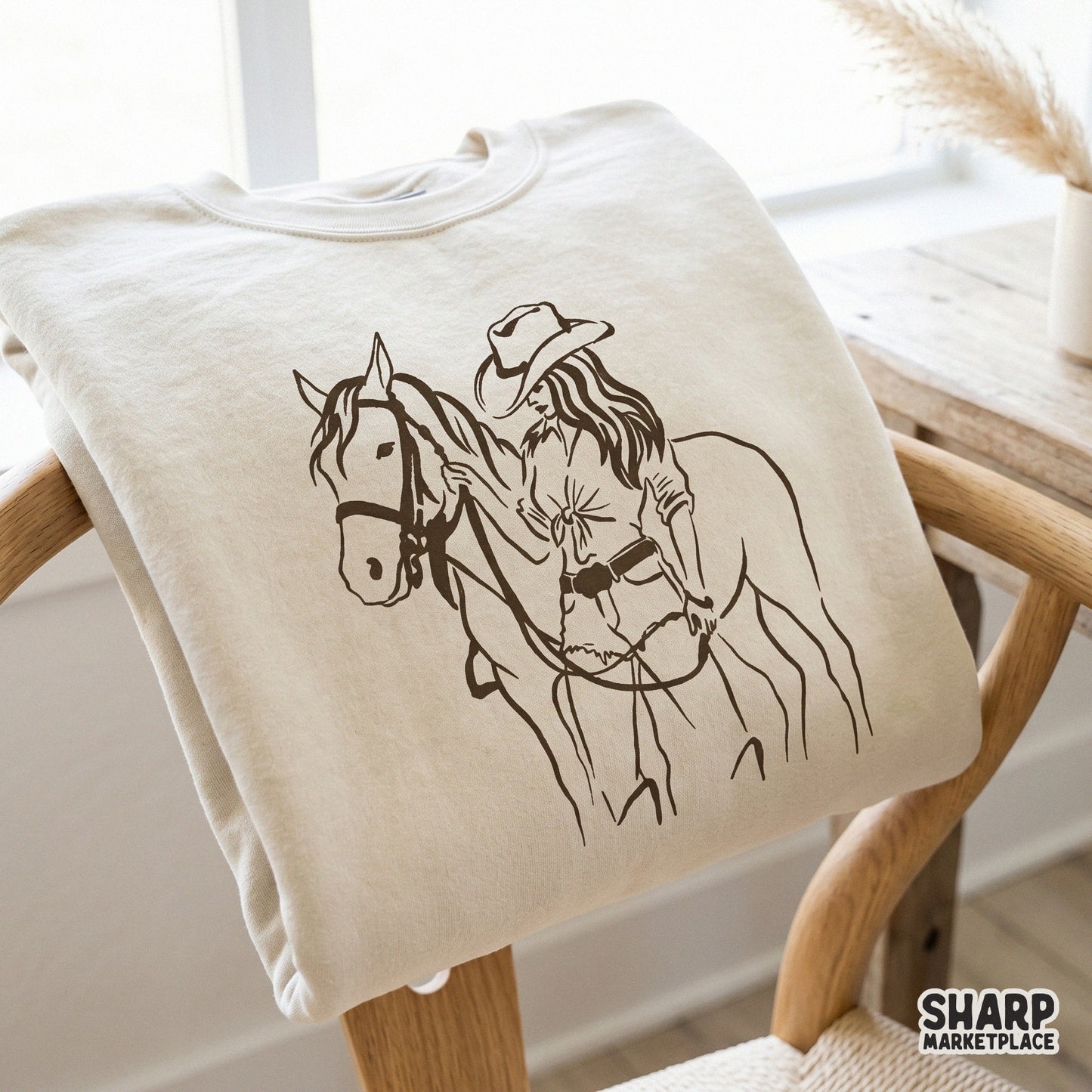Elegant western-inspired sketch of a cowgirl with her horse, a versatile digital graphic for DIY projects, custom clothing, and trendy ranch-themed gifts.