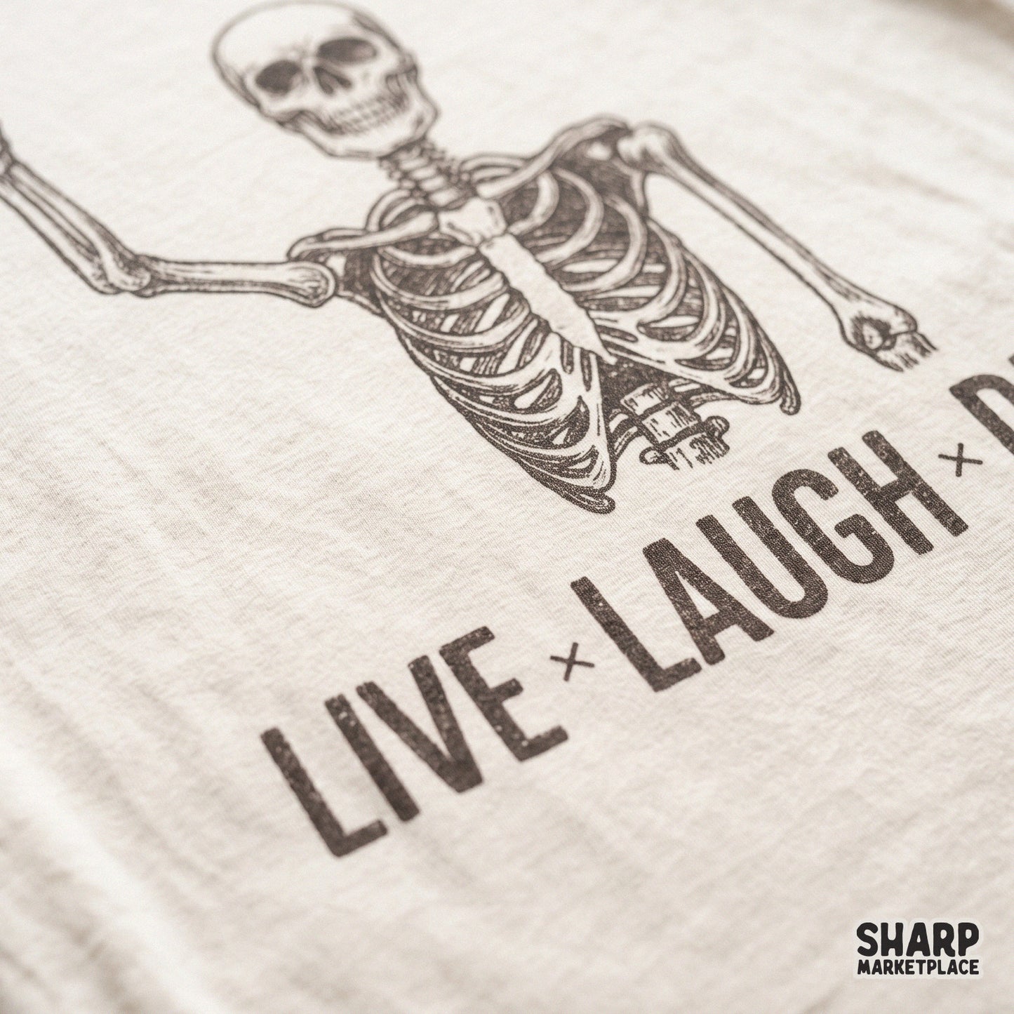 Funny skeleton skull graphic with Live Laugh Die sarcastic text in a retro Halloween style for spooky season shirts