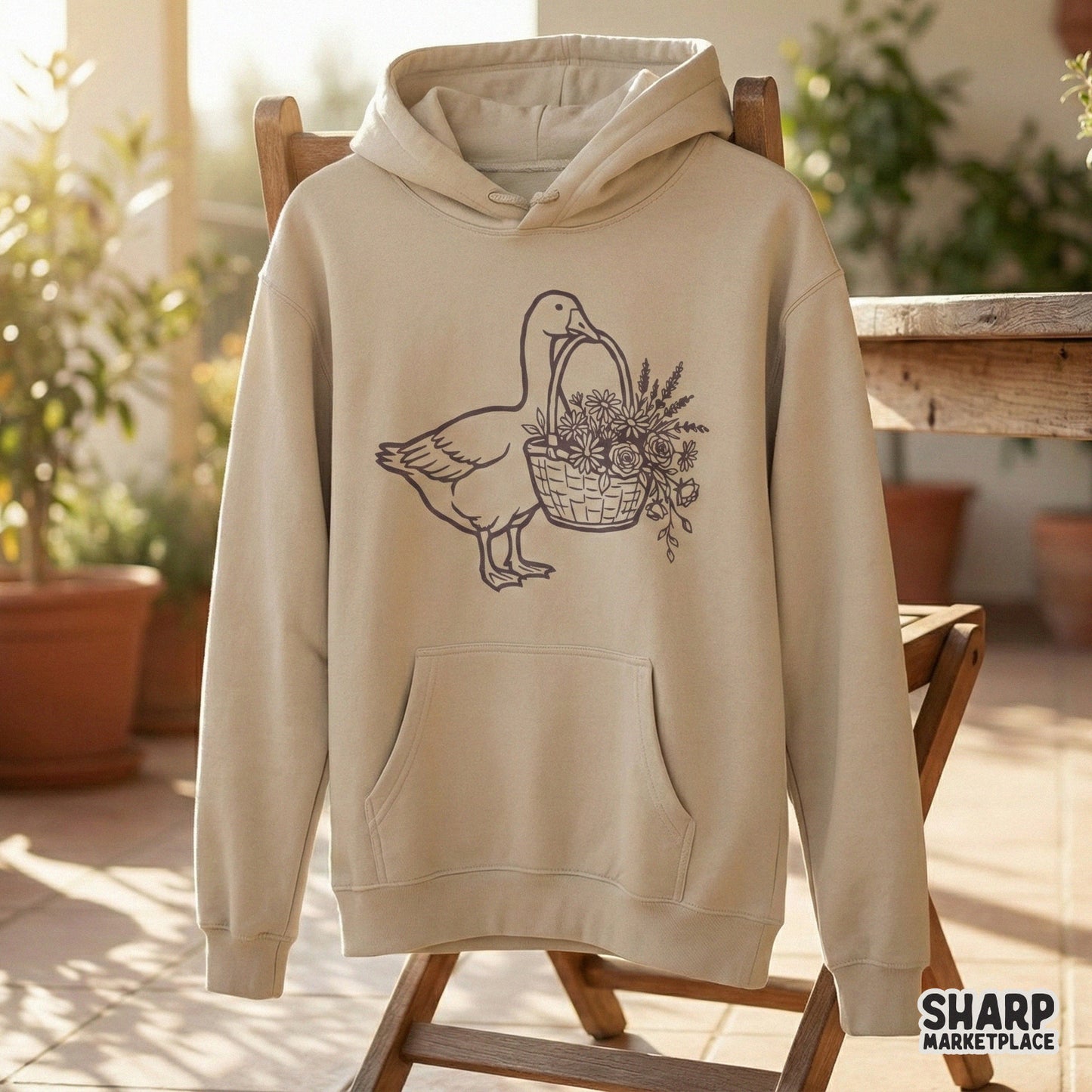 Detailed botanical goose graphic featuring a woven basket filled with blooming roses and daisies, ideal for creating custom apparel or seasonal home decor.