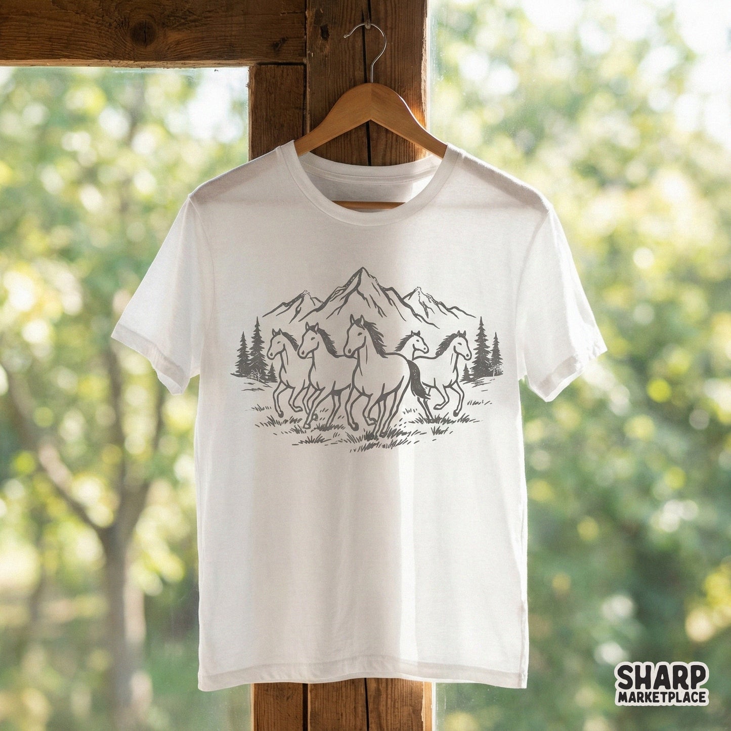 Hand-drawn western style graphic of wild horses in a mountain setting, ideal for creating custom shirts, stickers, or rustic home decor projects.