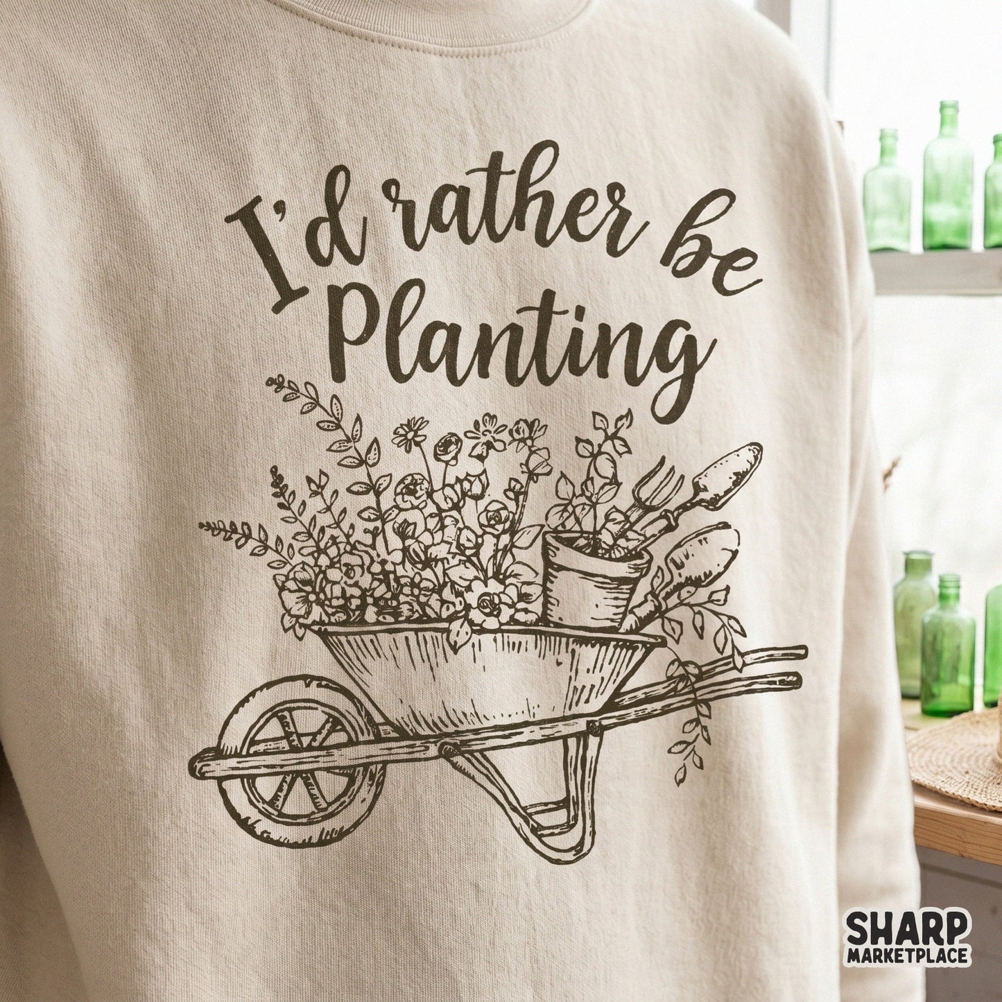 Elegant gardening-themed digital graphic featuring a wheelbarrow, spring blooms, and hand-lettered text for DIY craft and apparel projects.