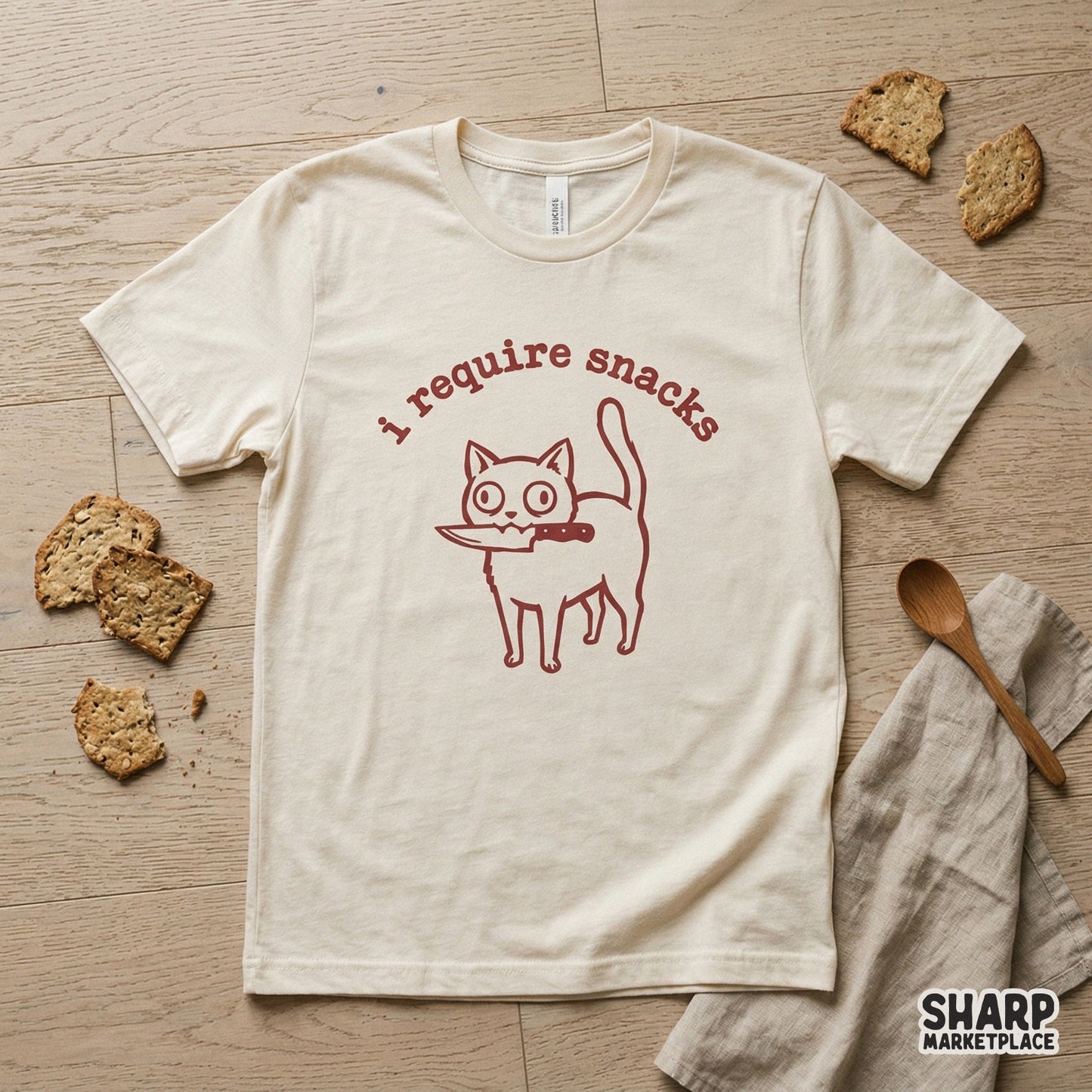 Sarcastic cat design with a knife and the words I require snacks in a rustic red font, suitable for custom stickers, tumblers, and graphic t-shirt projects.