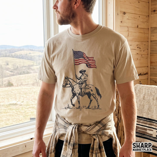 Vintage cowboy on a horse holding an American flag in a patriotic western PNG design for retro apparel sublimation