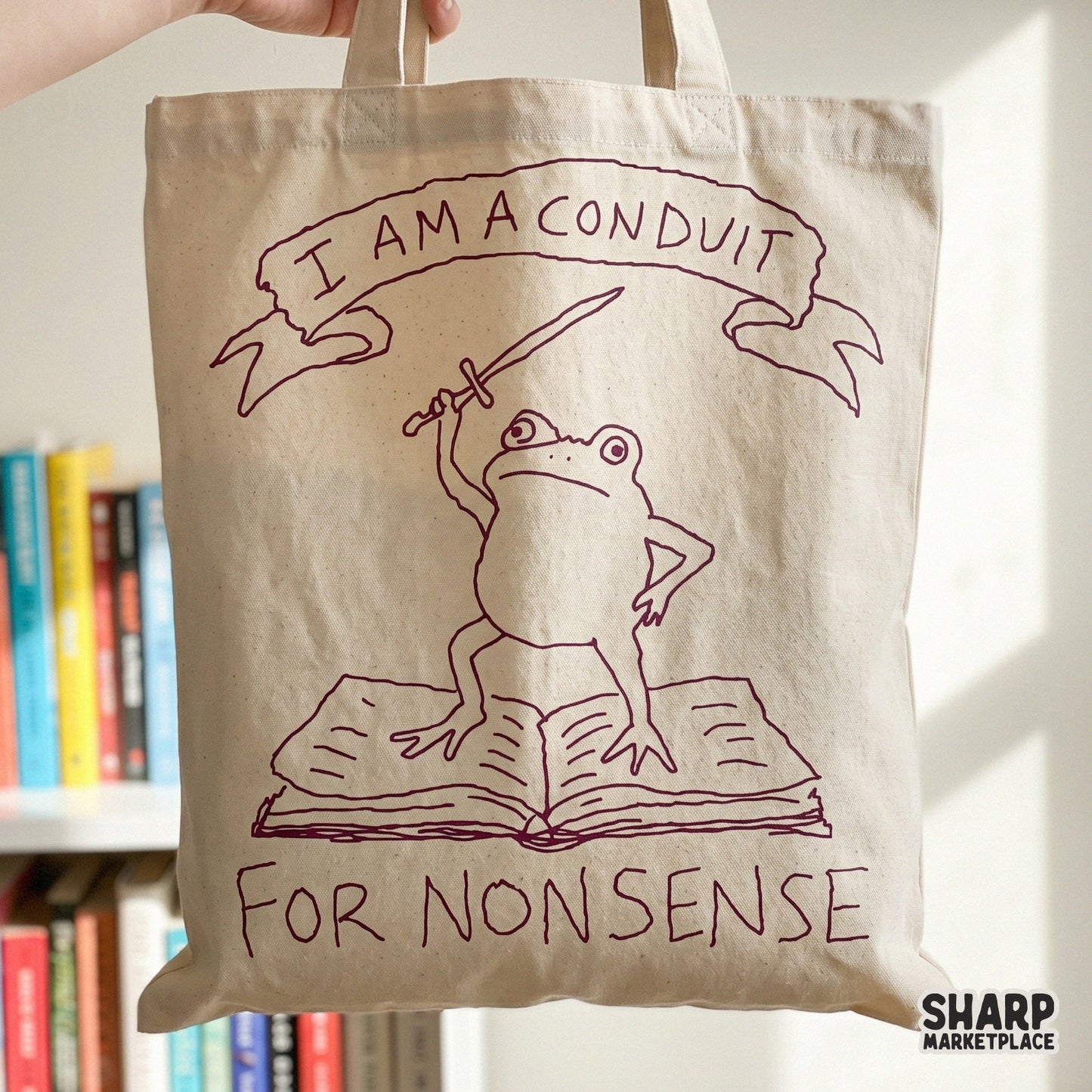 Sarcastic frog design with a sword and book, perfect for sublimation, stickers, or apparel featuring the quote I Am A Conduit For Nonsense.