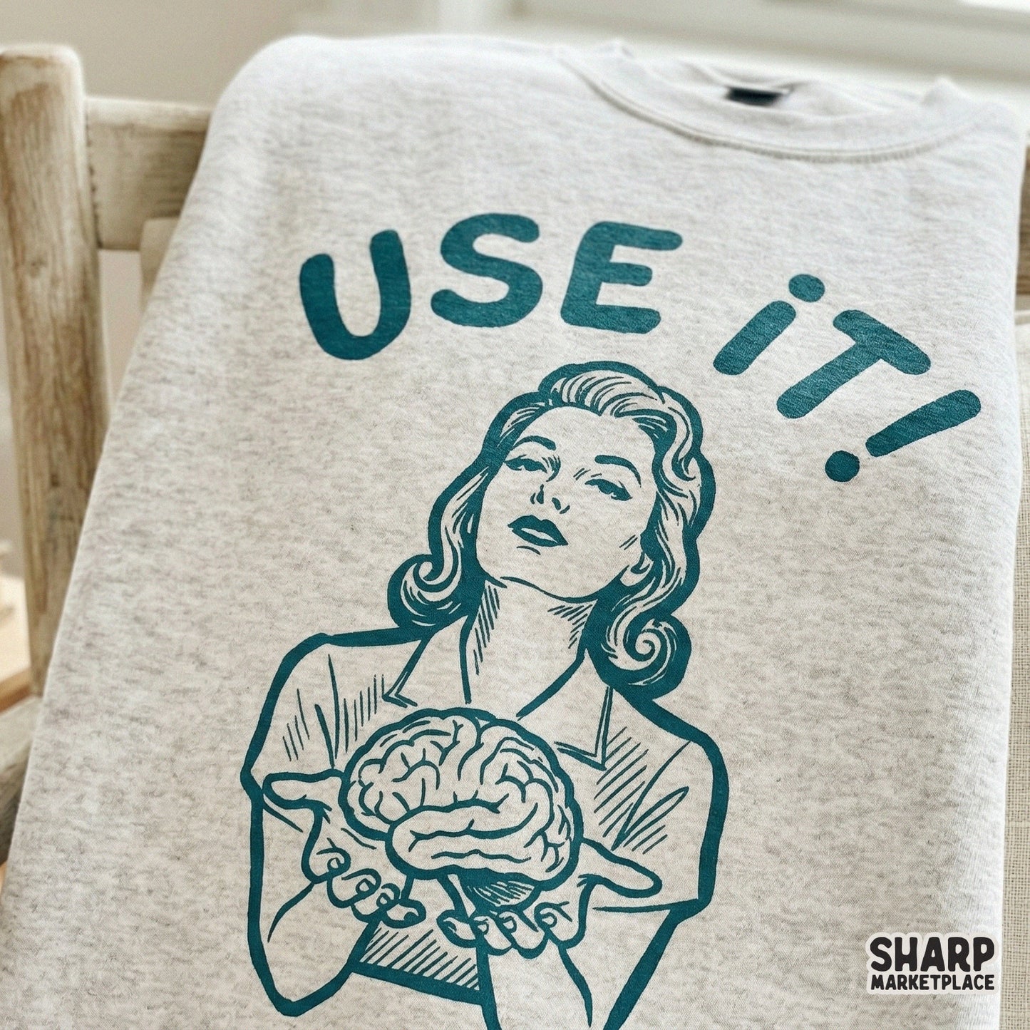 Monochromatic teal illustration of a woman holding a brain with the phrase Use It, designed for high-quality sublimation transfers and DIY craft projects.