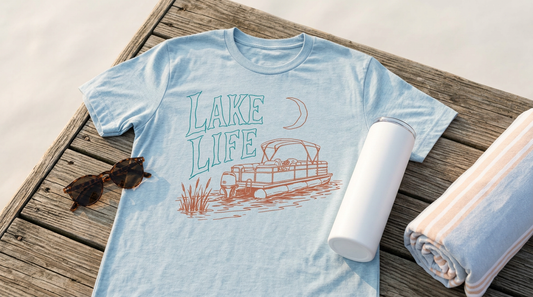 A blank light blue t-shirt and a white 20oz skinny tumbler styled on a wooden dock surface with vintage sunglasses