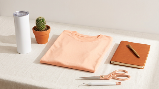 A trendy boho Christian t-shirt mockup surrounded by crafting tools and sublimation transfers on a clean workspace.