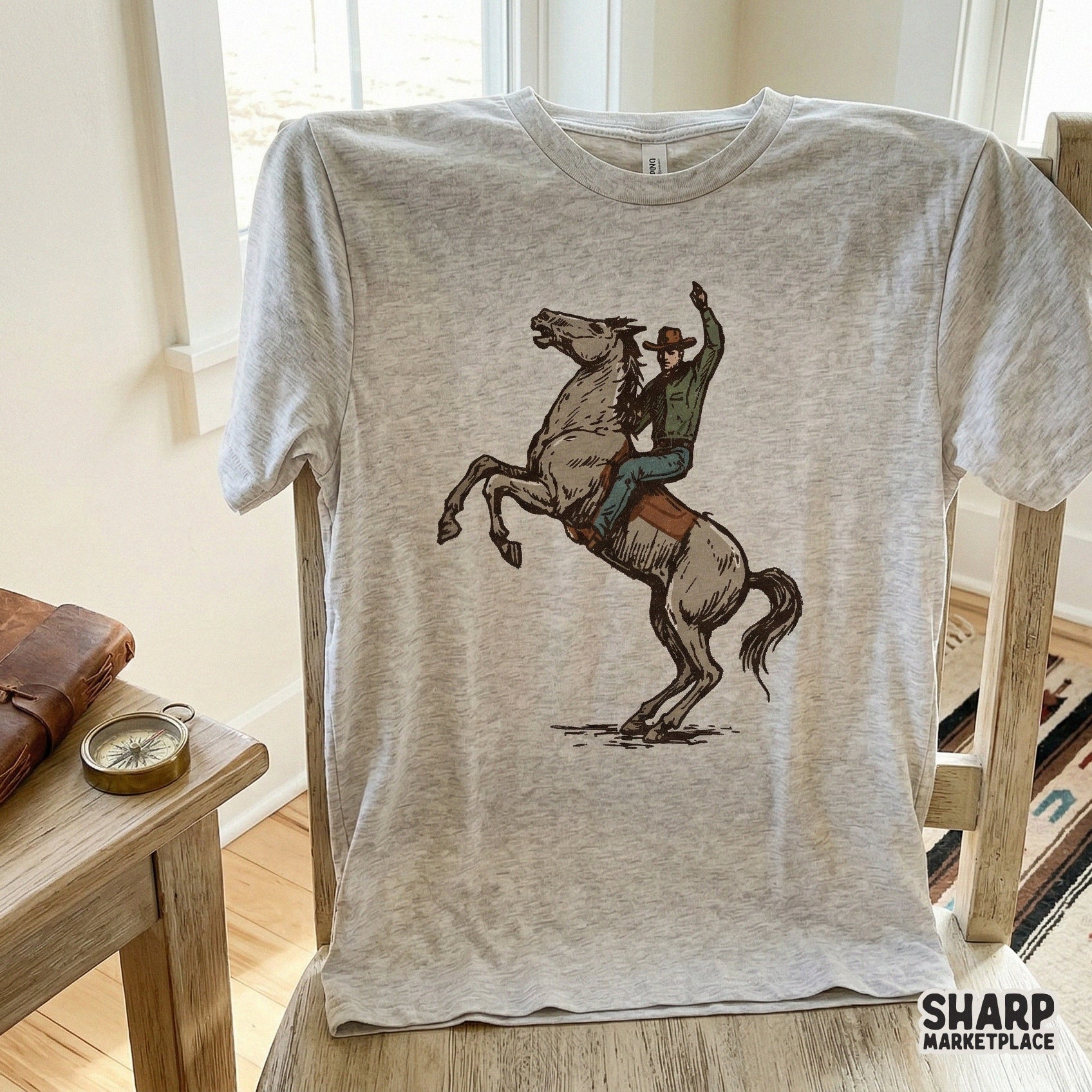 Detailed western art of a cowboy in a brown hat riding a rearing horse, suitable for high-quality sublimation transfers and ranch-style apparel.