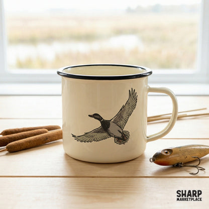 Rustic mallard duck illustration printed on a cream-colored enamel mug, showcasing detailed waterfowl wing feathers for a classic lake life aesthetic.