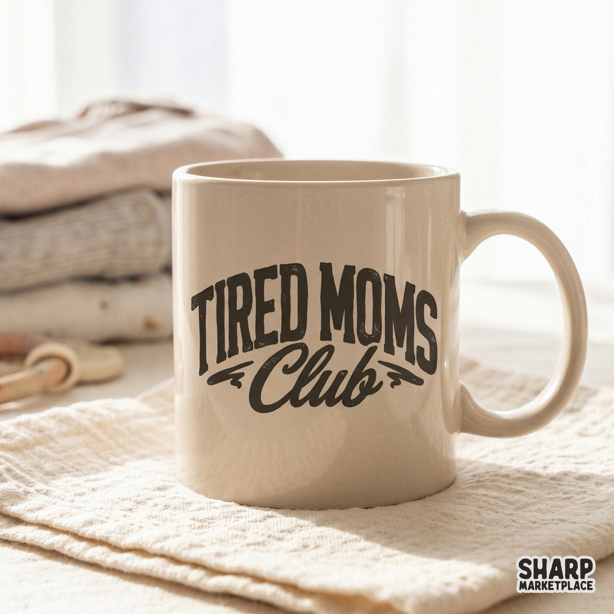 Distressed charcoal Tired Moms Club graphic shown on a ceramic mug, featuring a vintage-inspired layout perfect for sarcastic mom life apparel and DIY gifts.