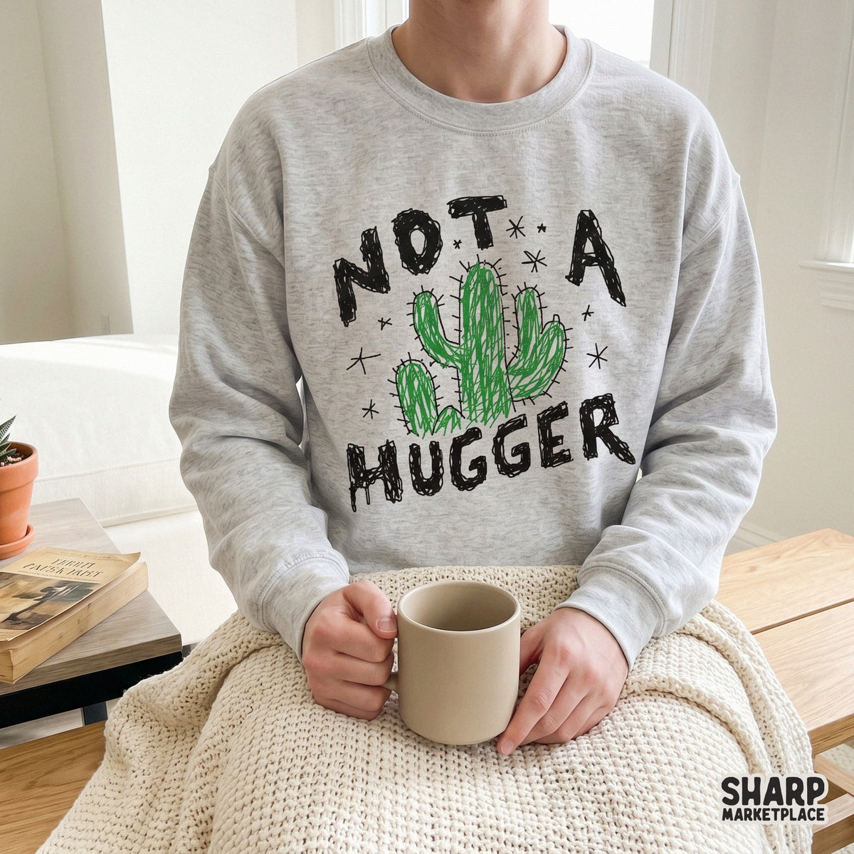 Trendy Not A Hugger cactus design displayed on a heather grey sweatshirt, showcasing a sarcastic western style for custom apparel and sublimation.