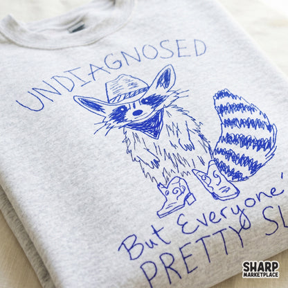 Trendy western-style raccoon illustration with messy blue typography, designed for DTF printing, apparel, and sarcastic custom gift projects.