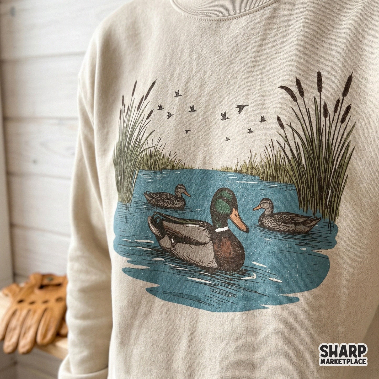 Retro mallard ducks swimming in a pond with cattails for a fall hunting sublimation shirt design