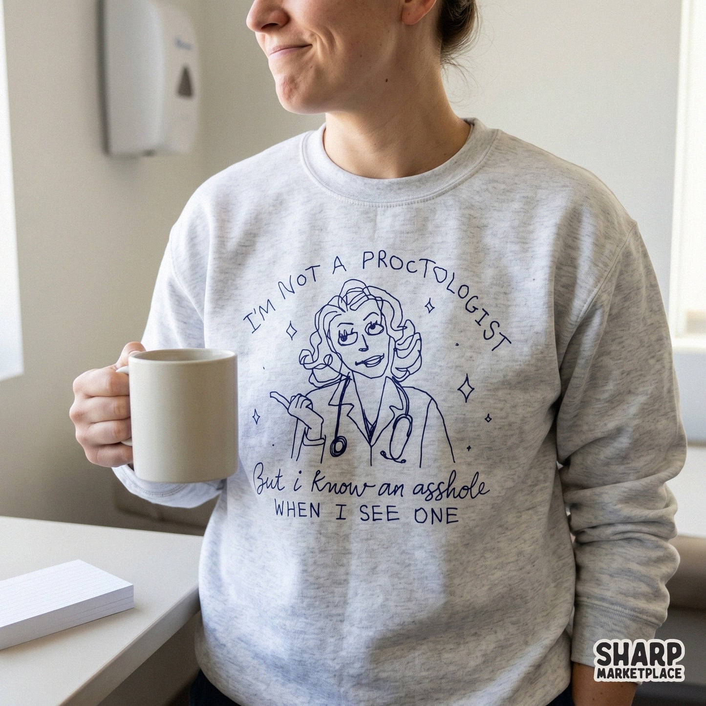 Sarcastic medical humor design featuring a doctor illustration and witty text, shown printed on a light gray sweatshirt for a trendy apparel look.