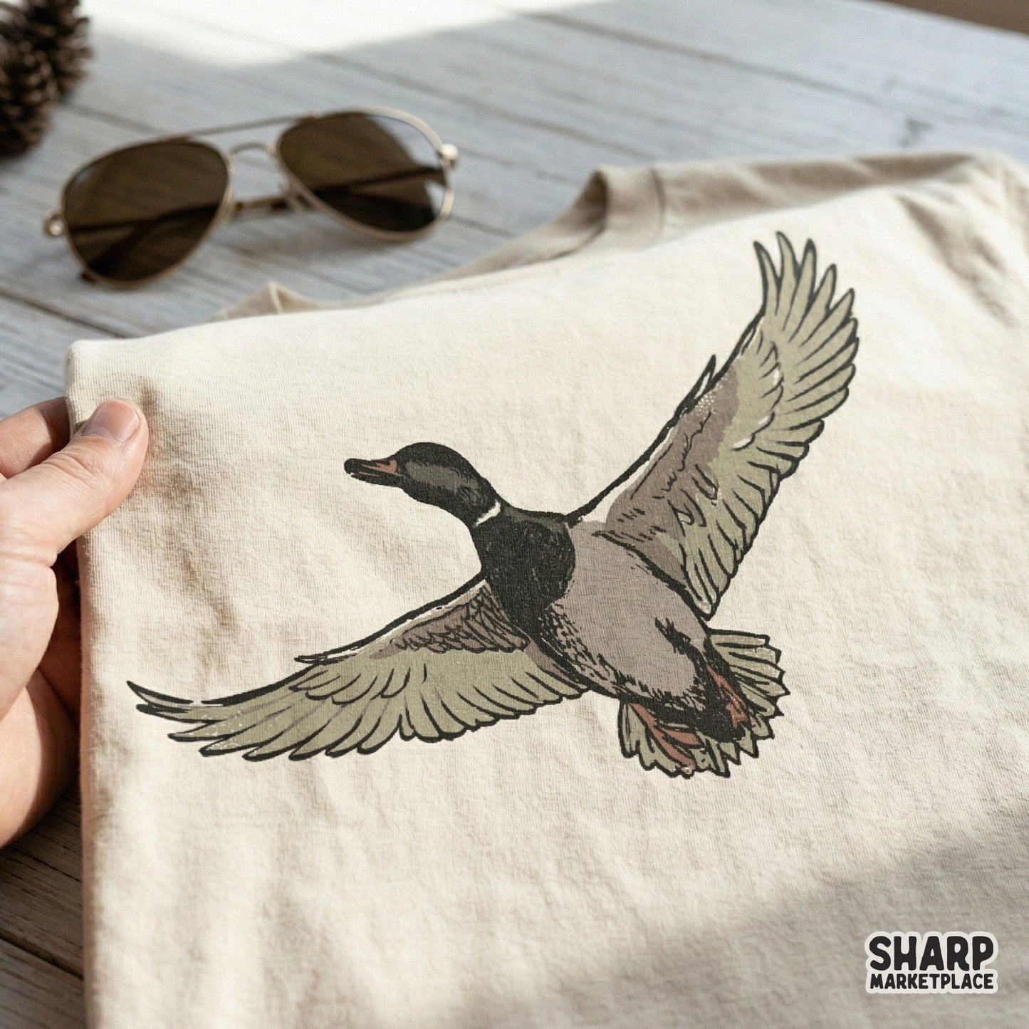 Detailed hand-drawn flying mallard duck graphic with a transparent background, perfect for sublimation printing on shirts, tumblers, or outdoor gear.