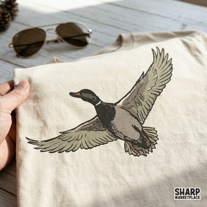 Detailed hand-drawn flying mallard duck graphic with a transparent background, perfect for sublimation printing on shirts, tumblers, or outdoor gear.