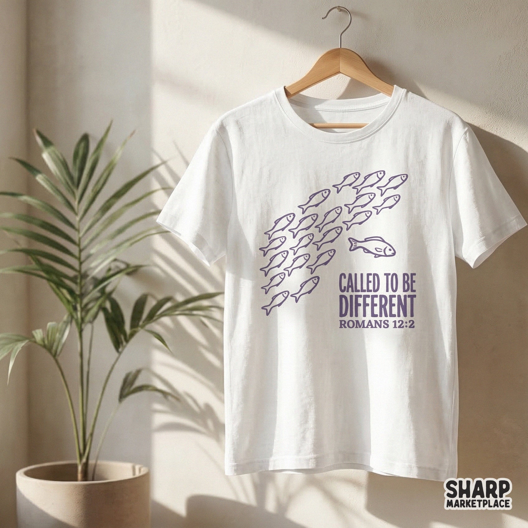 Sublimation design with purple hand-drawn fish and distressed block typography reading Called To Be Different Romans 12:2 for apparel and DIY projects.