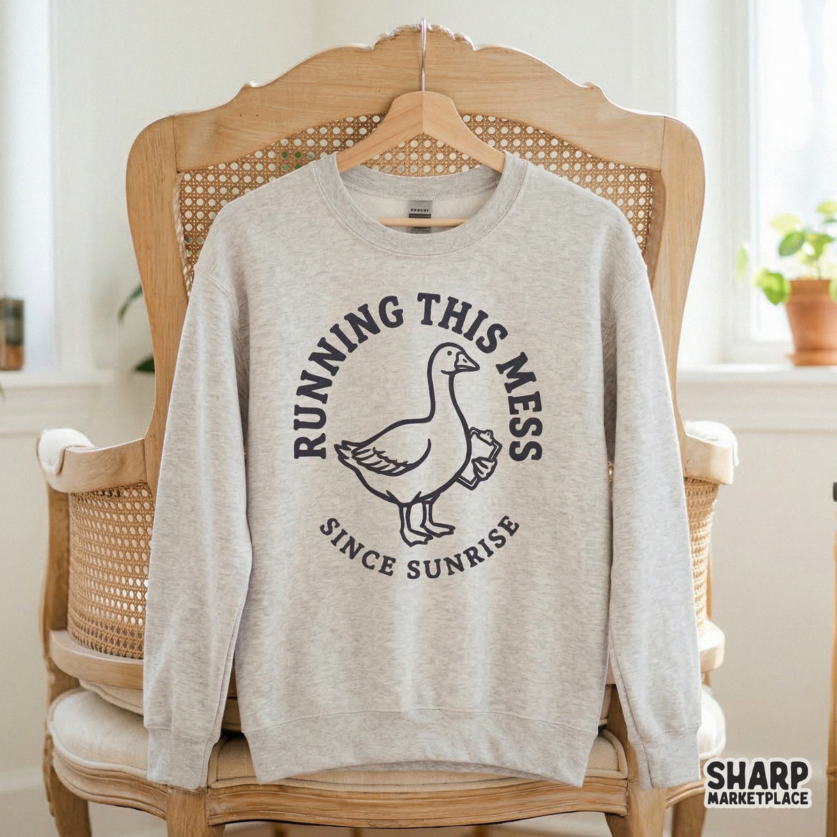Vintage-inspired goose illustration with a clipboard, designed for sublimation or apparel, featuring the humorous quote Running This Mess Since Sunrise.