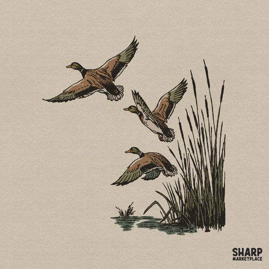 Rustic hand-drawn illustration of three flying mallards over marsh grass and reeds in earthy tones for hunting-themed apparel and wall art.