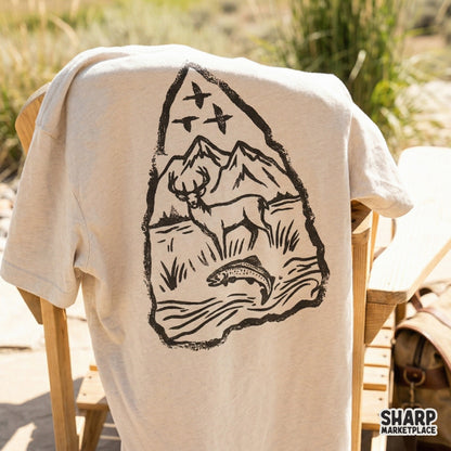 Hand-drawn monochromatic arrowhead design with a deer and trout, suitable for DIY fishing or hunting-themed projects and apparel printing.