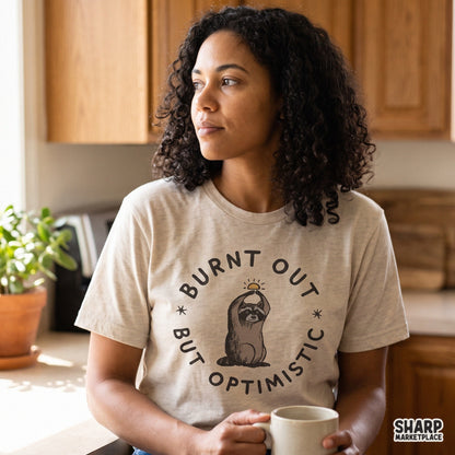 Burnt out but optimistic cute raccoon graphic with rising sun for funny t-shirt designs and sublimation PNG downloads