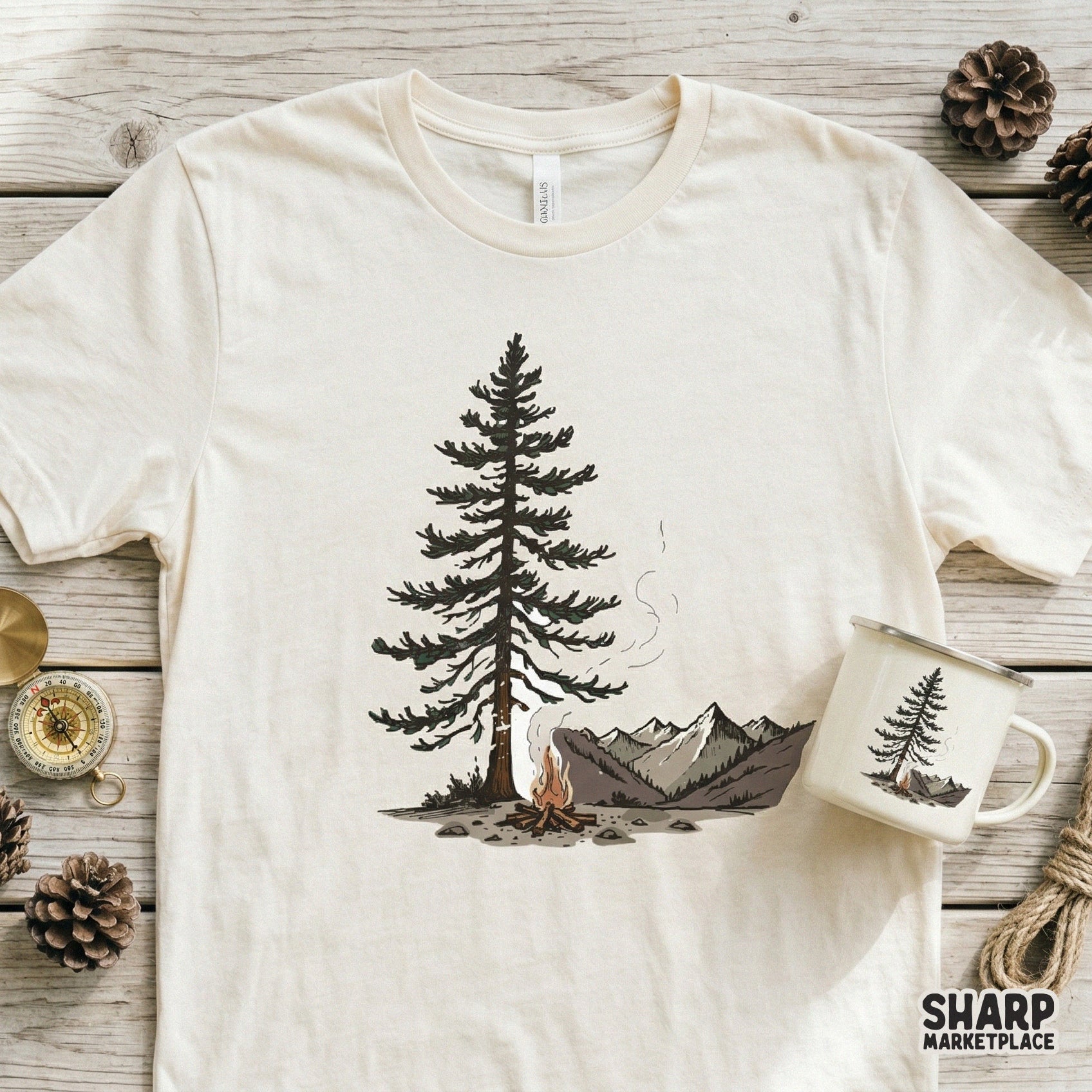 Rustic wilderness design featuring a pine tree and campfire with mountain backdrop, ideal for nature-themed t-shirts, stickers, and tumblers.