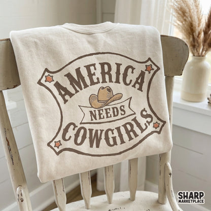 America Needs Cowgirls badge illustration with a vintage aesthetic, featuring star accents and a ribbon banner for custom sublimation and printable art.