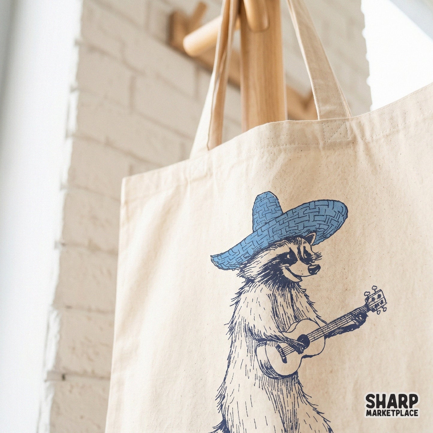 Detailed line art of a western-style raccoon with a blue sombrero and ukulele, ideal for creating custom stickers, tote bags, and unique printable gifts.