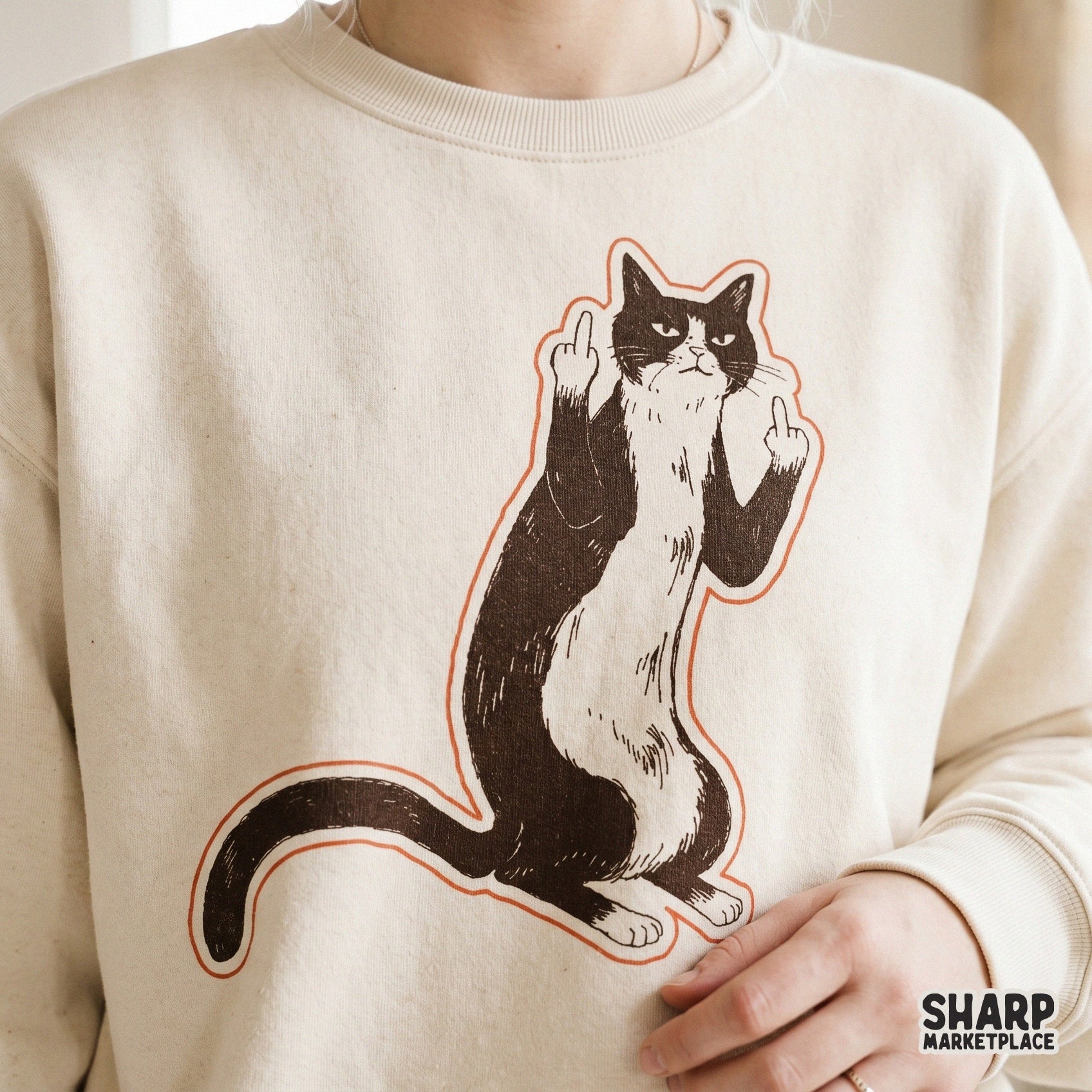 Detailed black and white tuxedo cat artwork with a subtle orange border, showing a rude feline flipping claws for unique sublimation and apparel.