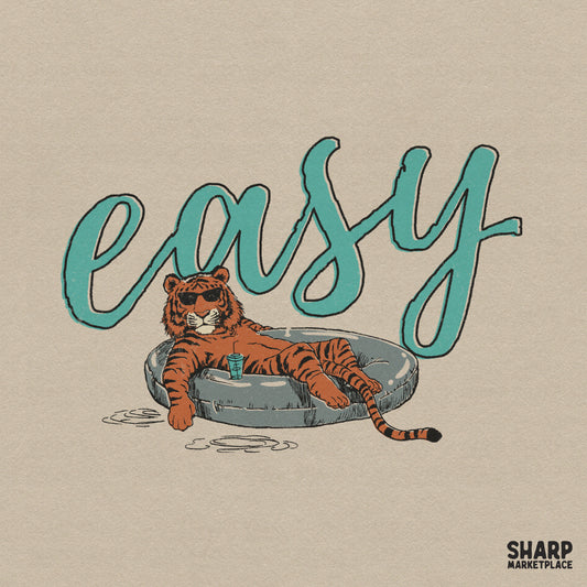 Retro summer design featuring a relaxed tiger wearing sunglasses and lounging in a pool float with the teal script word easy above it.
