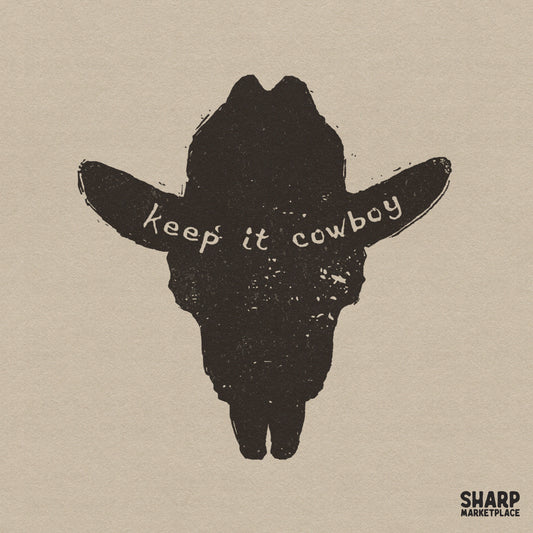 Distressed black silhouette of a steer skull shaped like a cowboy hat with the text keep it cowboy, isolated on a neutral background.