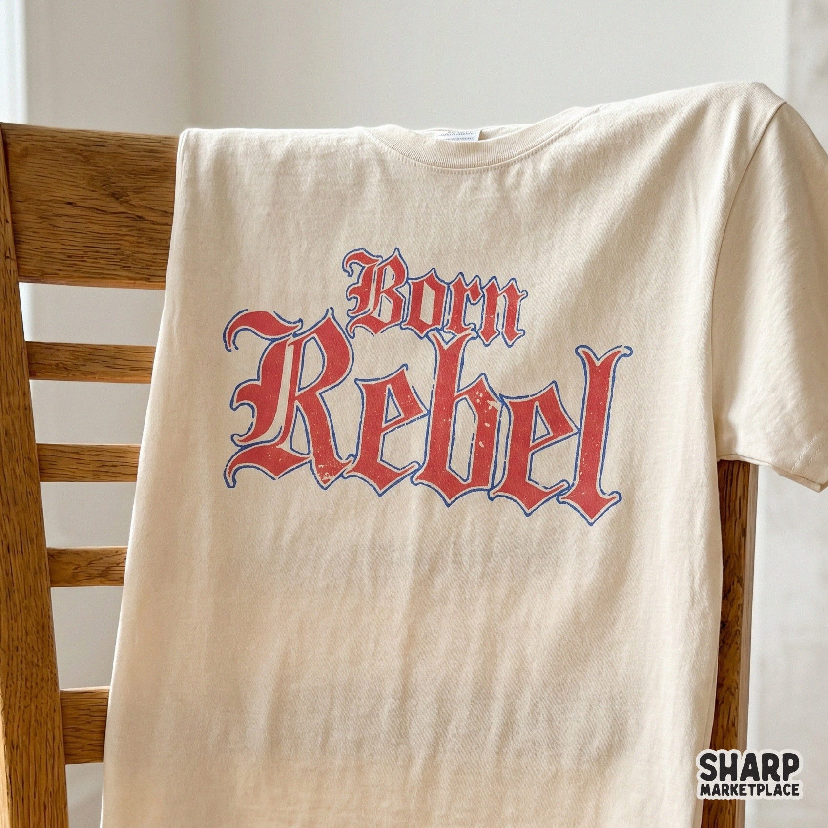 Bold Born Rebel typography in a distressed red and blue gothic font, suitable for sublimation transfers, custom stickers, and rugged apparel designs.