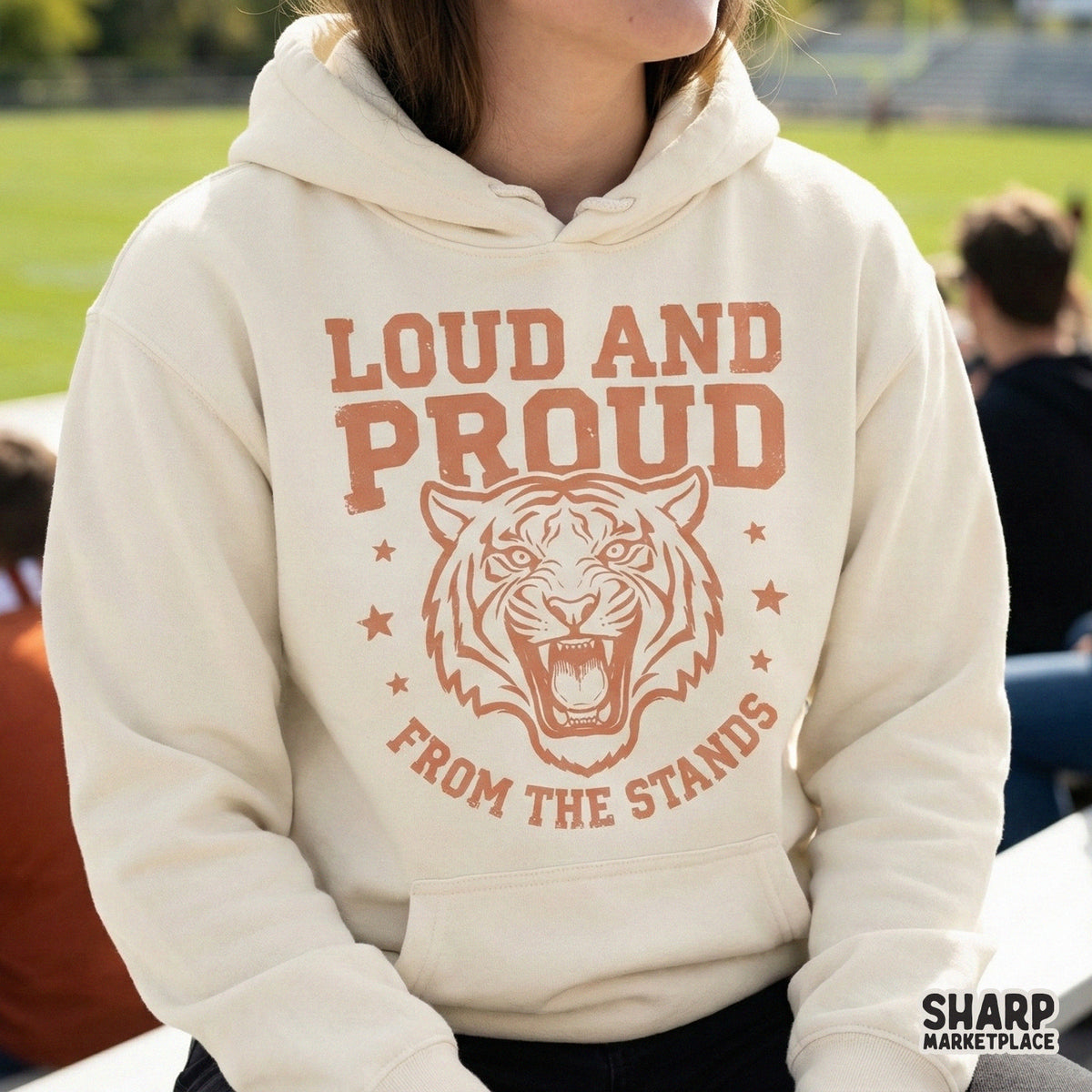 Retro sports themed digital design featuring a fierce tiger head and the quote Loud and Proud from the Stands, perfect for school spirit gear.