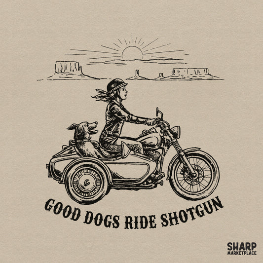 Vintage black ink illustration of a woman riding a motorcycle with a dog in a sidecar, featuring a desert canyon landscape and the text Good Dogs Ride Shotgun.