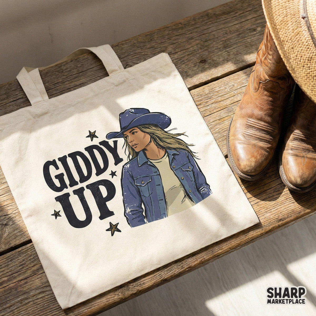 Vintage-style western graphic featuring a cowgirl in a denim outfit and Giddy Up lettering, shown as a digital print on a canvas tote bag.
