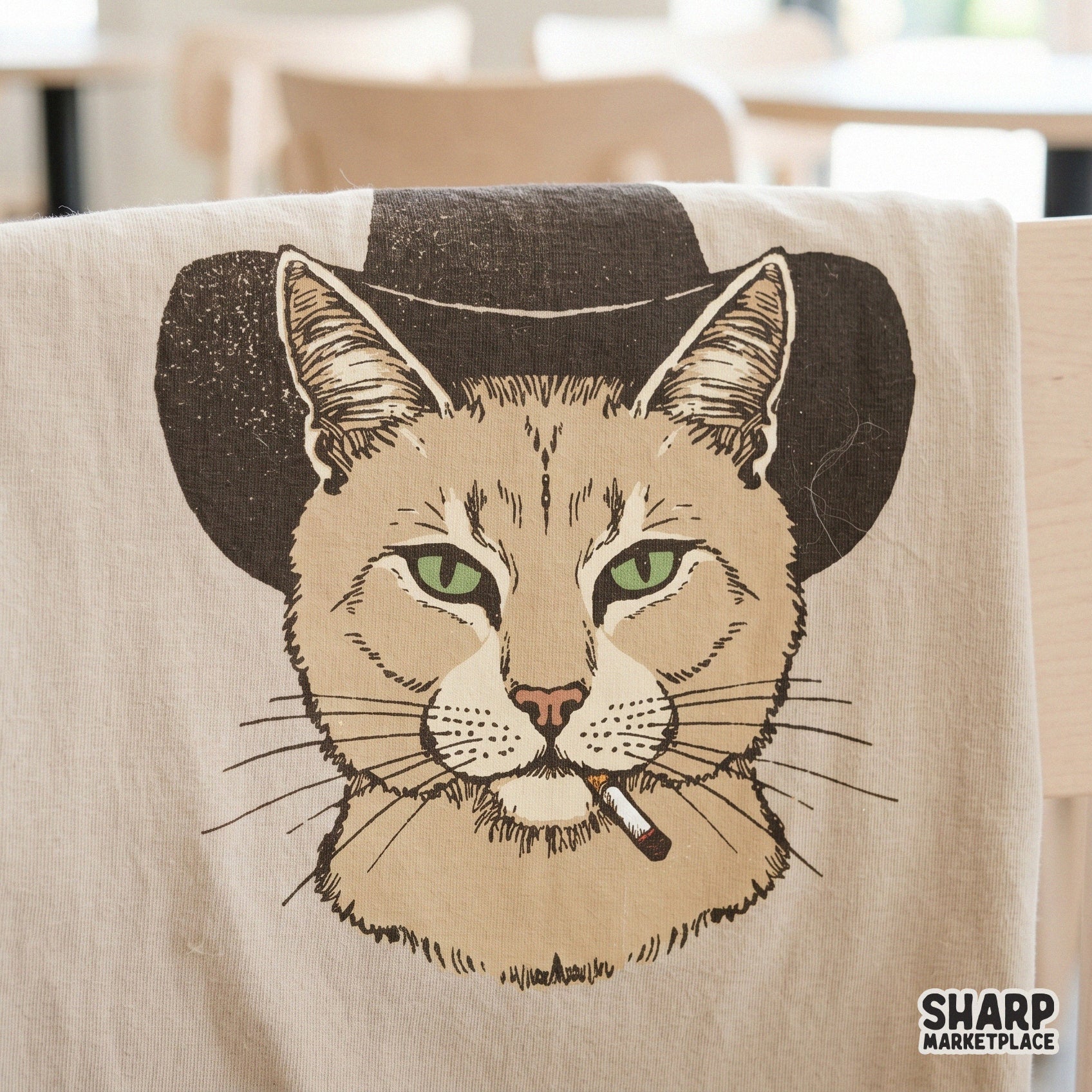 Retro-style cowboy cat graphic featuring a tough feline in a western hat and cigarette, printed on a fabric surface for custom apparel projects.