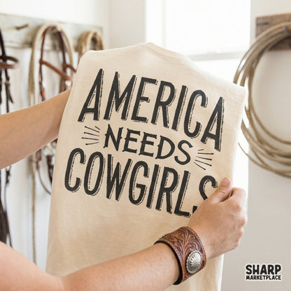 Rustic western graphic featuring the quote America Needs Cowgirls in block letters with speed lines, perfect for custom rodeo t-shirts and sublimation.