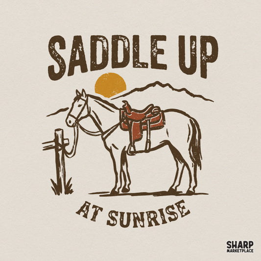 Vintage western design with a saddled horse at a post, mountain backdrop, and the text Saddle Up At Sunrise in a distressed rustic style.