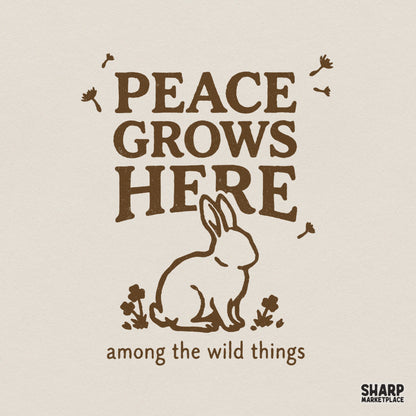 Vintage-style brown design featuring a hand-drawn bunny silhouette surrounded by wildflowers and the text Peace Grows Here among the wild things.