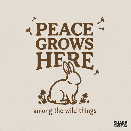 Vintage-style brown design featuring a hand-drawn bunny silhouette surrounded by wildflowers and the text Peace Grows Here among the wild things.
