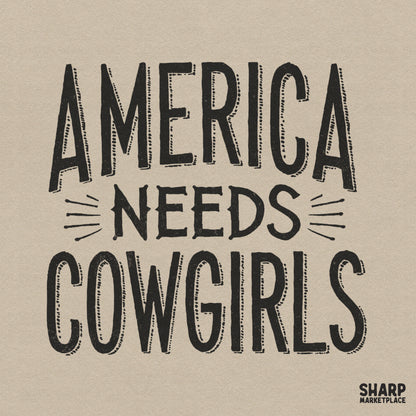 Bold black typography reading America Needs Cowgirls with a distressed vintage texture and western style for patriotic apparel and ranch decor.