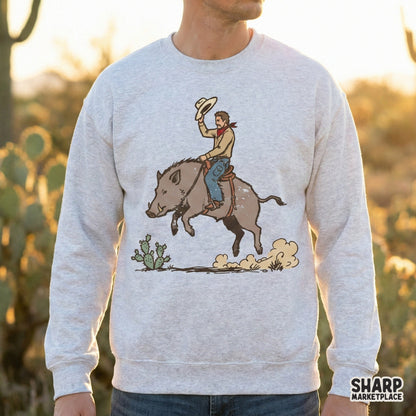Western rodeo digital graphic featuring an outlaw cowboy on a saddled boar, perfect for sublimation, t-shirts, stickers, and custom desert-themed apparel.