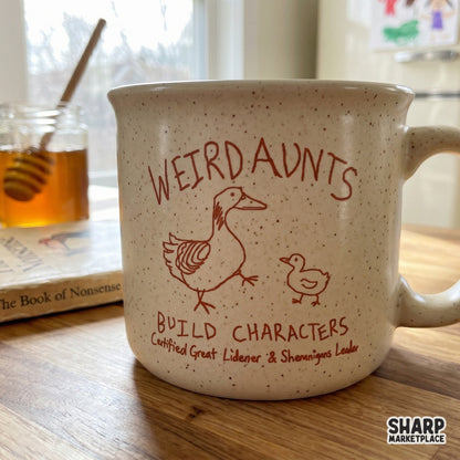 Rustic orange hand-drawn goose illustration on a speckled ceramic mug, featuring the quote Weird Aunts Build Characters and Shenanigans Leader.