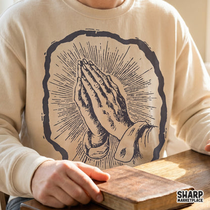 Praying hands with radiant light Christian PNG illustration for religious shirt designs and faith based devotional art