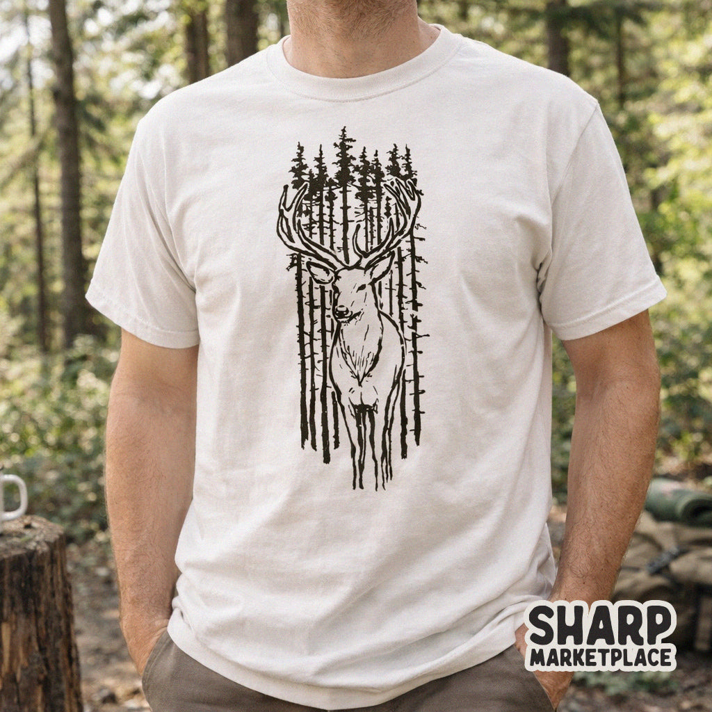 A white t-shirt mockup displaying a rustic deer and pine forest sketch, perfect for hunting-themed apparel or woodland-inspired DIY projects.