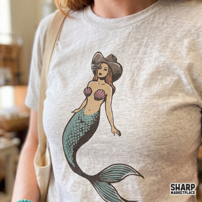 Vintage cowgirl mermaid wearing a cowboy hat in a retro western style for summer beach apparel and DTG printing projects