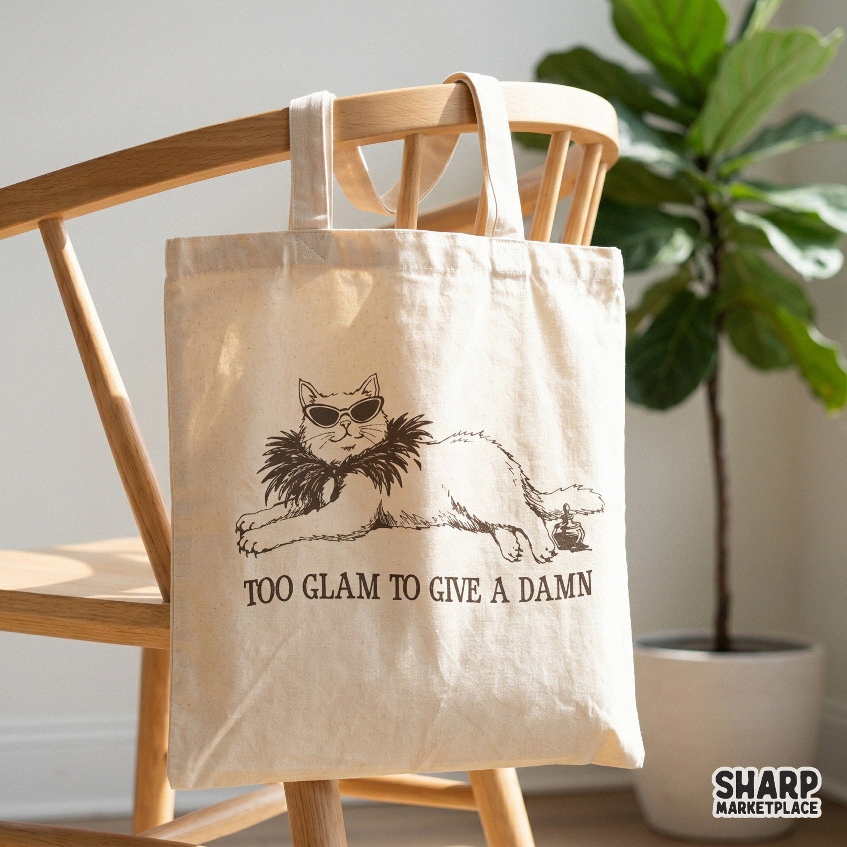 Funny cat graphic with sunglasses and a feathered boa, featuring the text Too Glam To Give A Damn for use on shirts, tumblers, and DIY crafts.